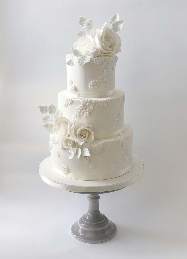 White Embossed cake with Sugar Roses Wedding Cakes